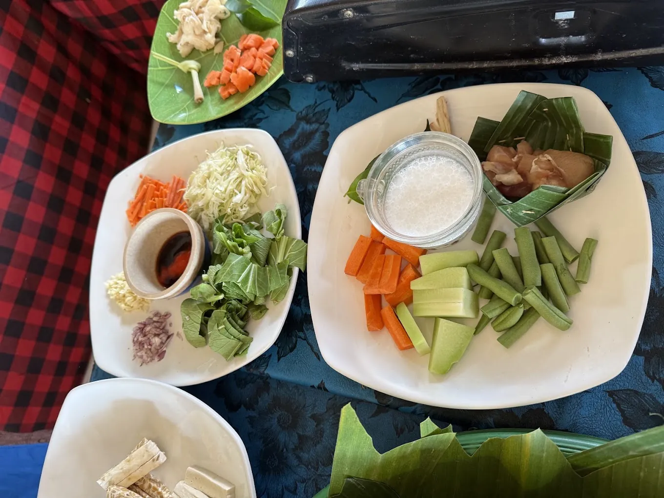 Chopped long beans, grated coconut, coconut milk, and tempeh on the blue class table in Petulu, from the Petulu class where jukut urab is cooked